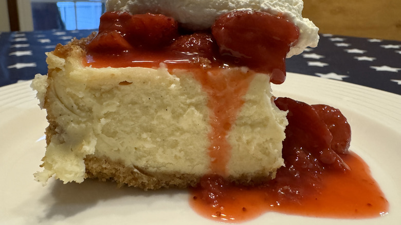 Strawberry cheesecake on white plate with stars in background