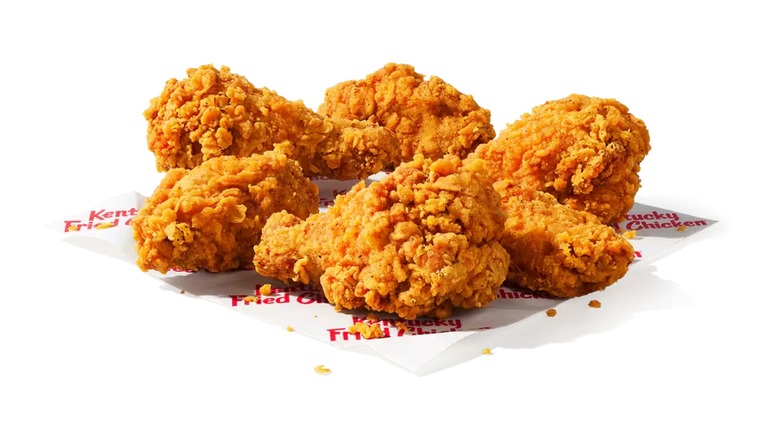 Fried chicken wings on KFC paper and a white background