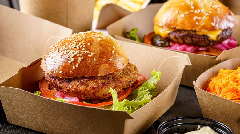burger and chicken sandwich in boxes
