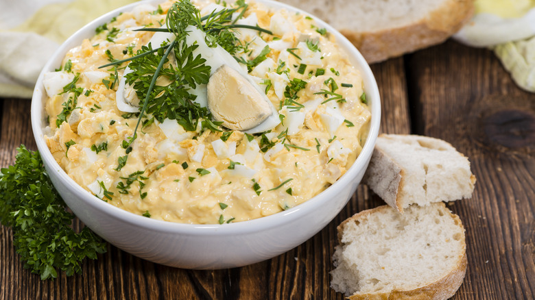 egg salad in bowl with bread