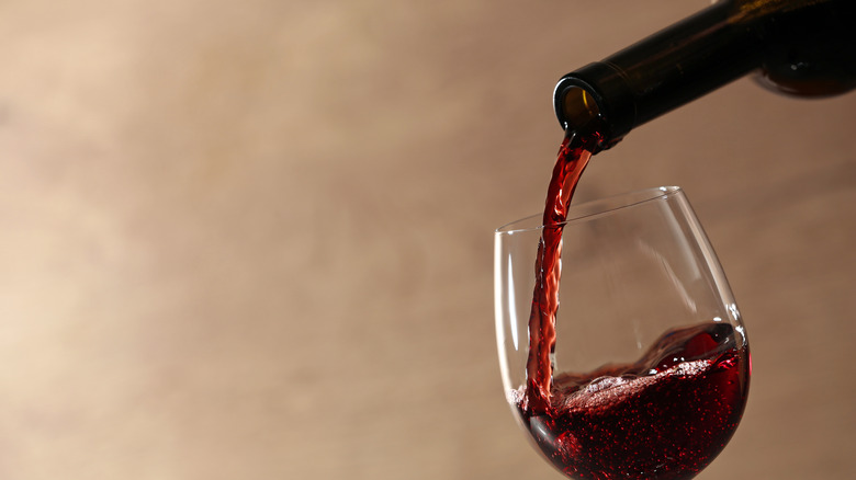 pouring red wine into glass