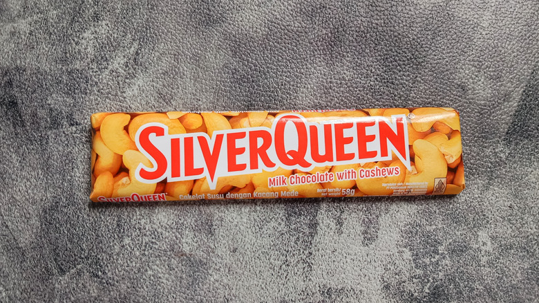 A bar of SilverQueen chocolate is on a textured grey background.