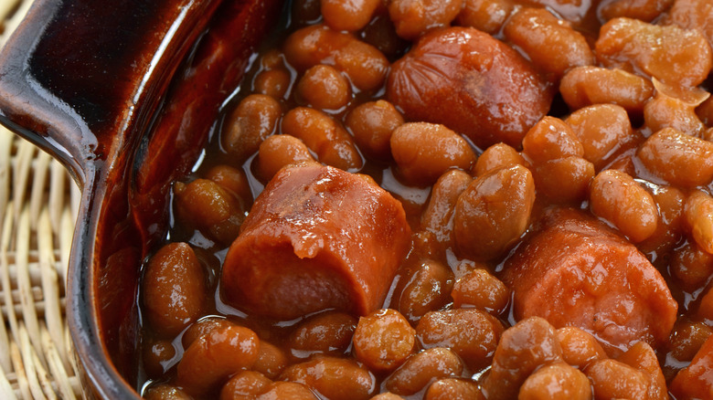 A close-up of beans and franks in a baking dish