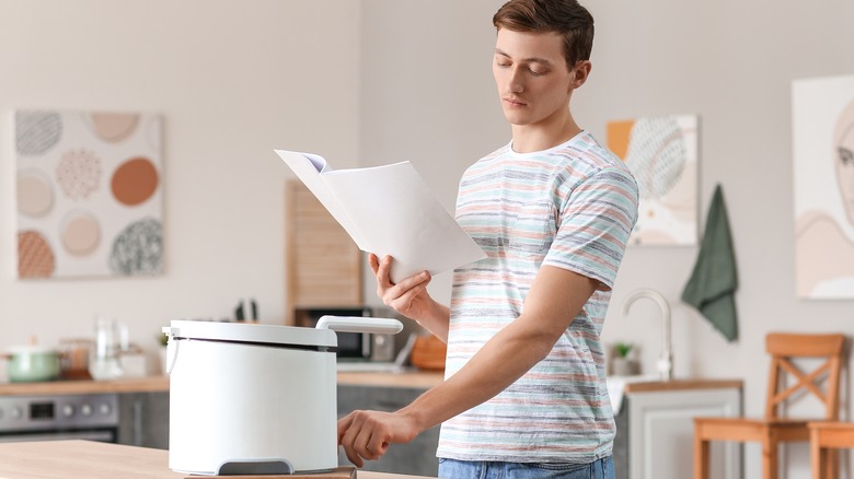 man reading manual for deep fryer