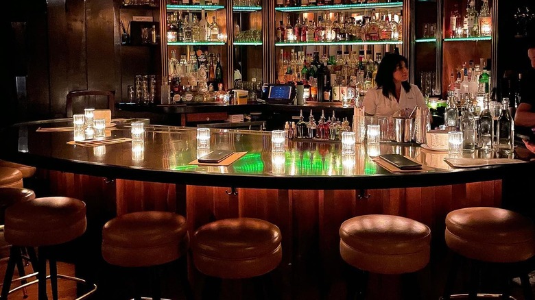 female bartender behind bar