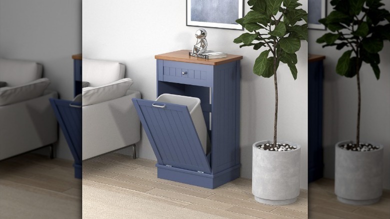 Antique title out trash can next to wall and couch