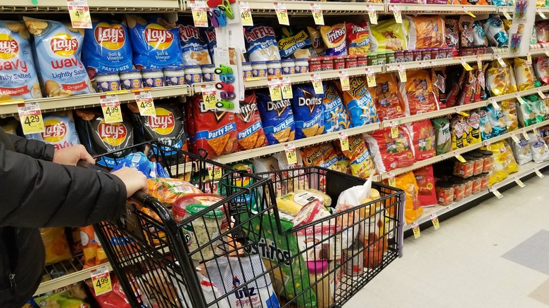 Shopping cart pushed through snack aisle