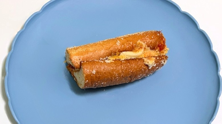 A Wawa pepperoni marinara hoagie on a blue plate against a white background