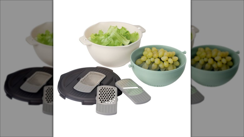 Product image of the Crofton colander and rotary grater set with grapes in a teal colander and lettuce in a white one against a white background.
