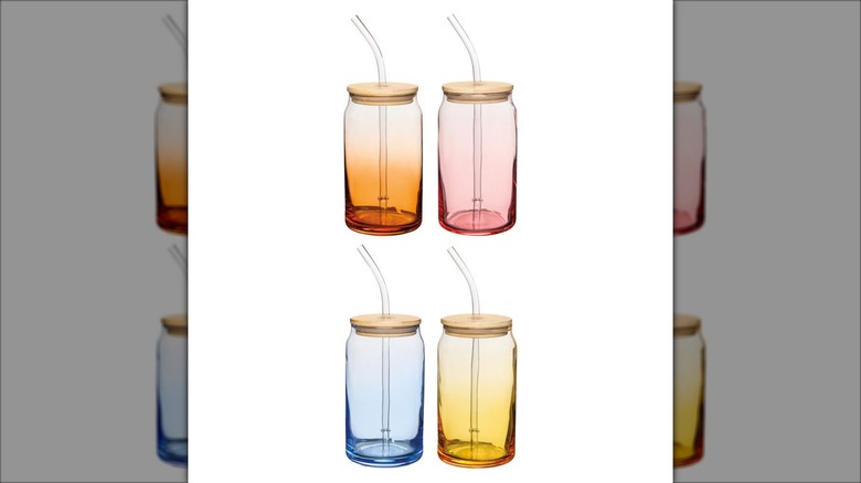 Product image of the Crofton glass drinking jars in ombre orange, light pink, baby blue, and golden yellow with bamboo lids and clear glass straws against a white background.