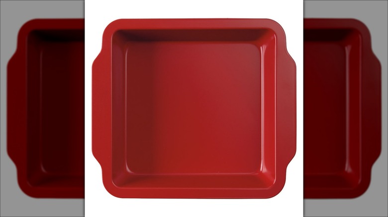Product image of a red square Crofton metal bakeware dish against a white background.