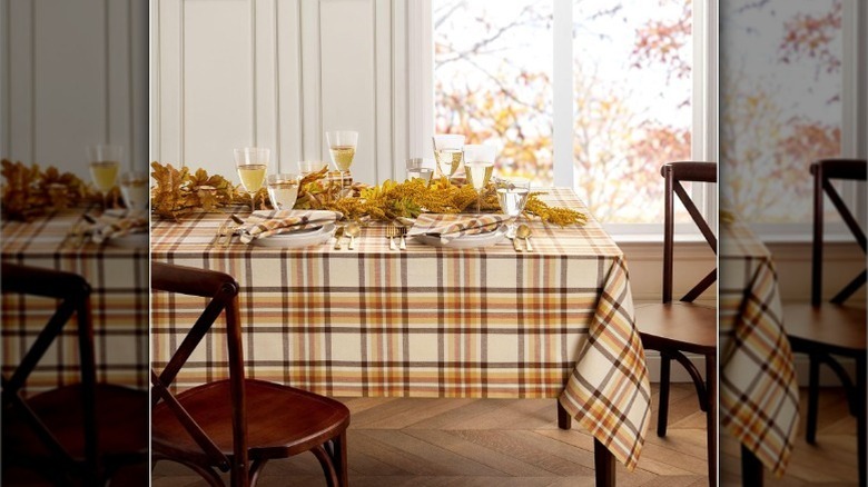 Orange and brown plaid tablecloth with drinks and decor