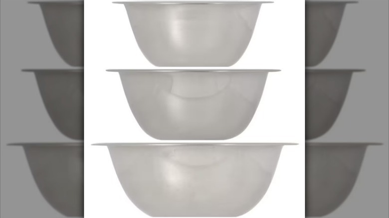 Three stainless steel mixing bowls on white background