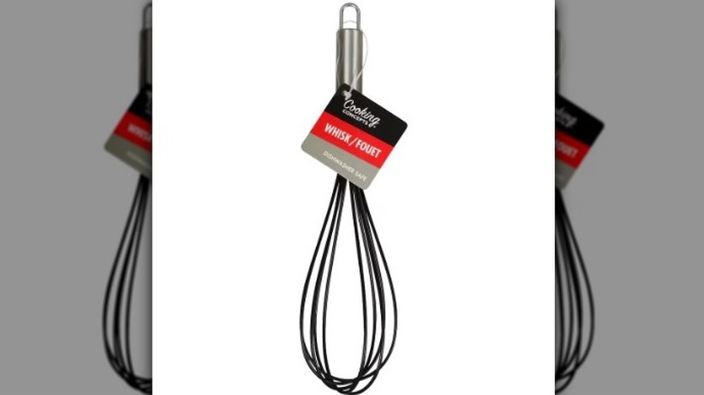 Black and metal whisk on white background