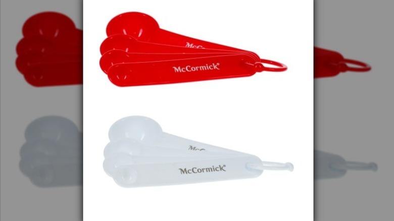 Red and white measuring spoon sets on white background
