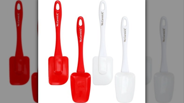 Red and white spatulas on white background