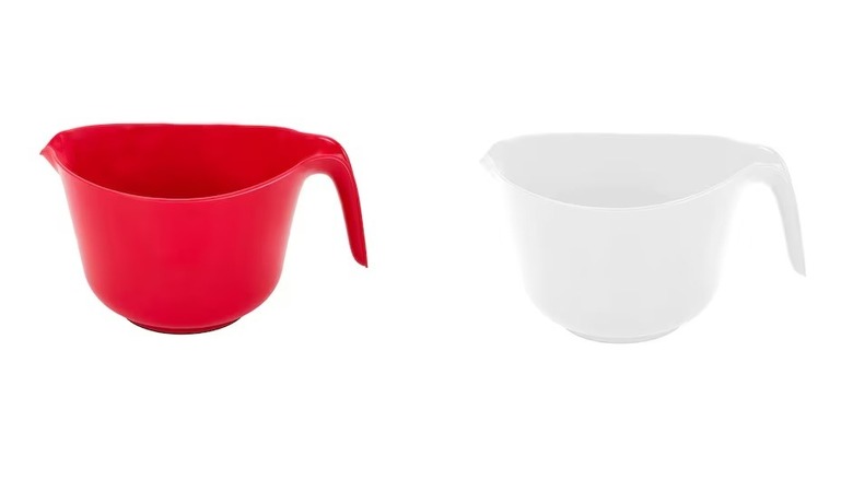 Red and white plastic mixing bowls with handles and spouts on white background
