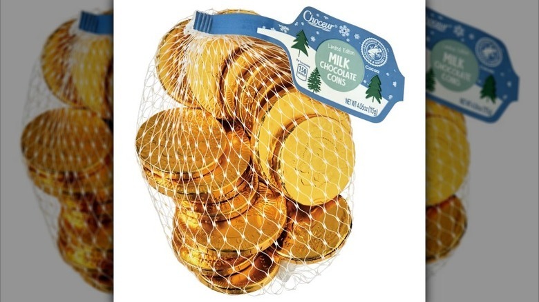 Milk chocolate coins on white background