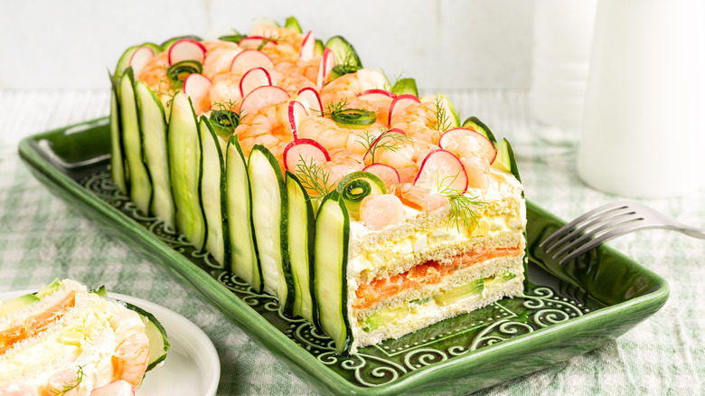 A Swedish style sandwich loaf with cucumber edges and elaborate garnishes