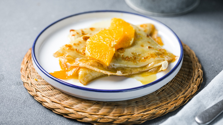 Crepes Suzette garnishes with orange wedges