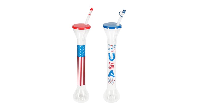 Two yard-long plastic cups with patriotic decorations and either red or blue lids