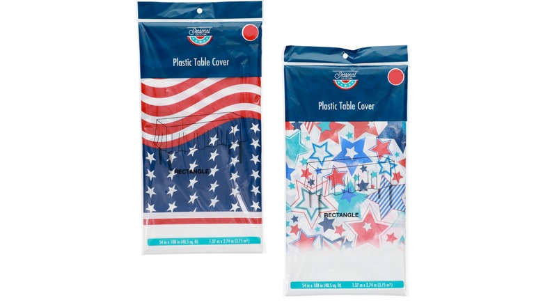 Bagged and folded plastic table covers, one in an American flag design and the other with red, white, and blue stars