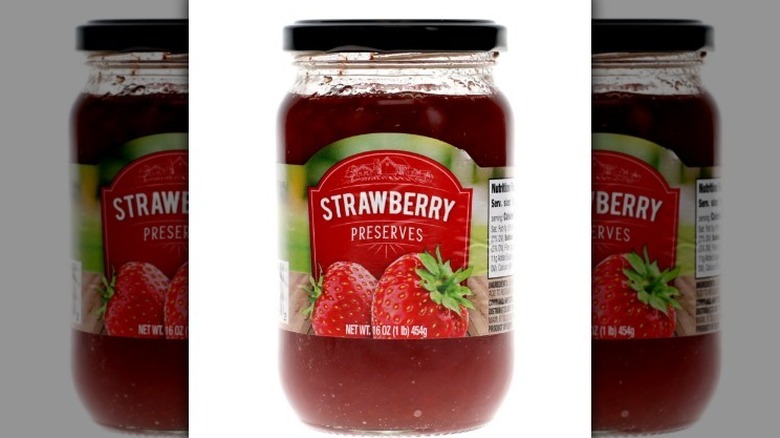 Strawberry preserves on white background