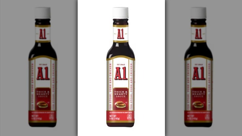 A bottle of A1 sauce with a white label and white lid on white background