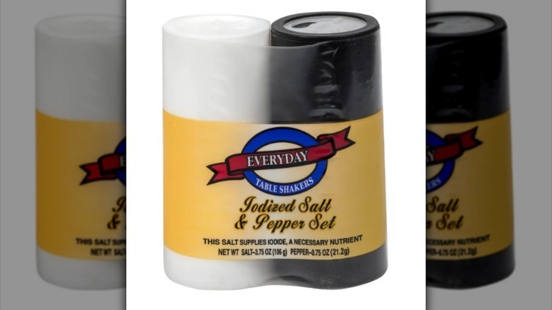 Salt and pepper set with a yellow plastic label on white background