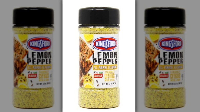 Lemon pepper seasoning with a black lid on white background