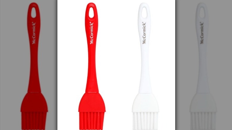 Silicone brush options in red and white on white background