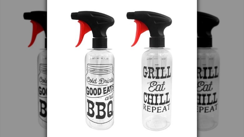 Printed spray bottle with black and red lid with text on the bottle "cold drinks, good eats and BBQ" and "grill, eat, chill, repeat" on white background