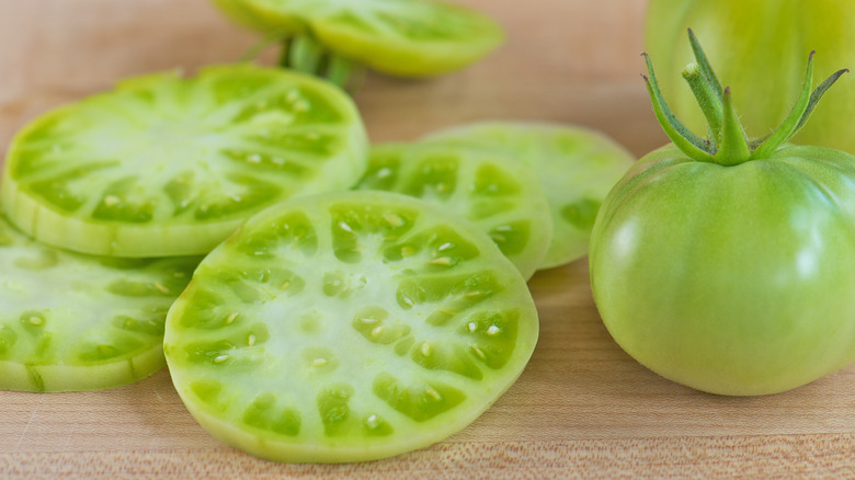 Whole and sliced green tomatoes