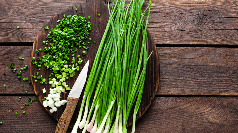 Scallions on wooden board