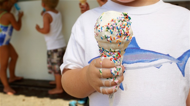 hand holding melting ice cream cone