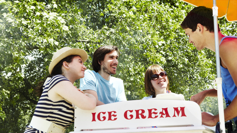 person serving ice cream from cart