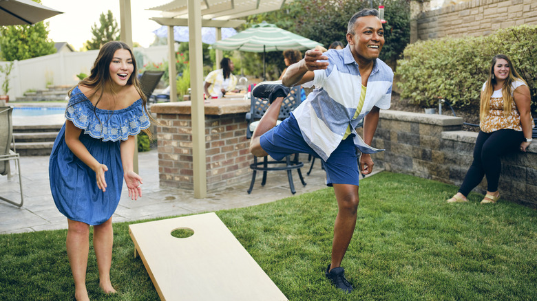 people playing cornhole