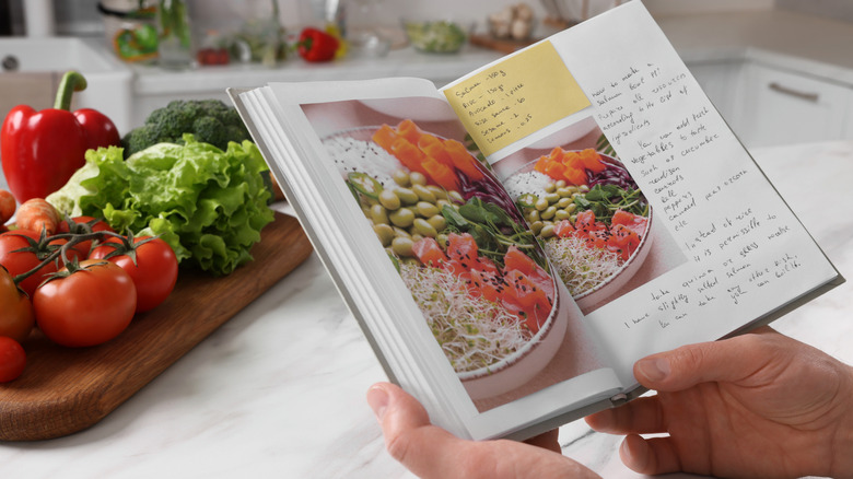 Person holding cookbook open