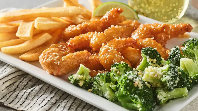 A plate of Tsunami Shrimp with fries and broccoli from Red Robin