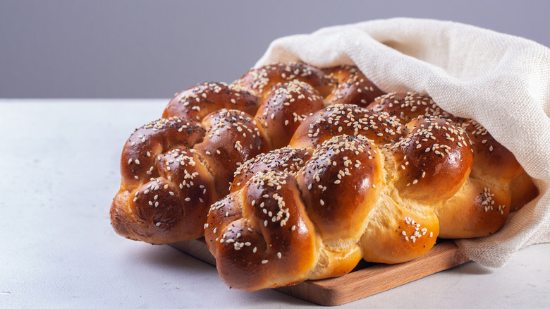 Braided challah on cutting board