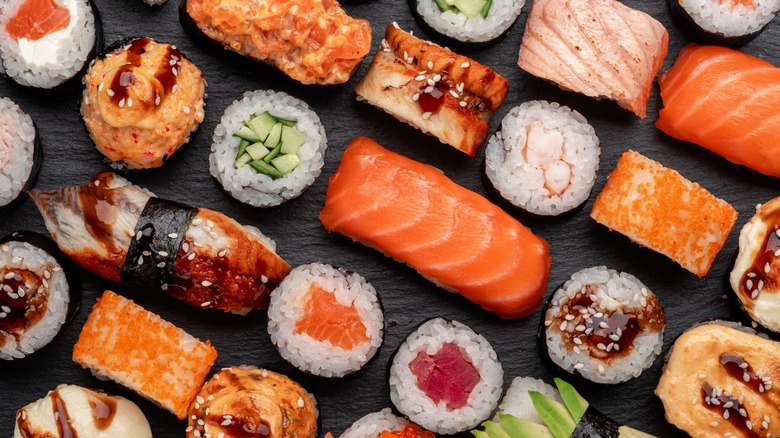 Assorted sushi on black slab