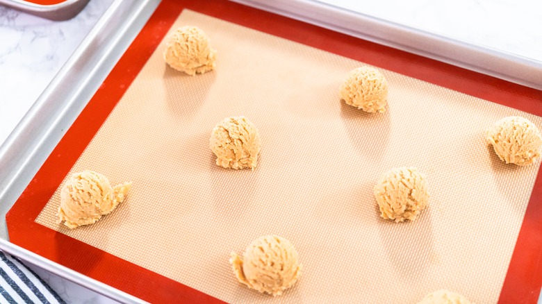 Cookie dough scooped on silicone mat