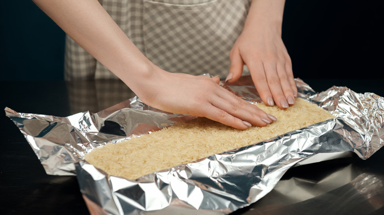 Person pressing rice into pan