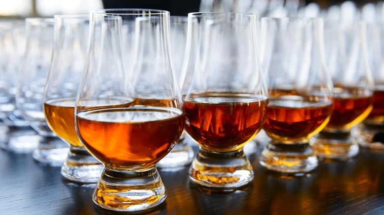 Rows of Glencairn glasses, some filled with bourbon or other whiskey