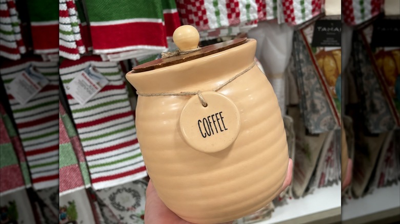 beige ceramic coffee jar with wooden top and twine with token that says coffee