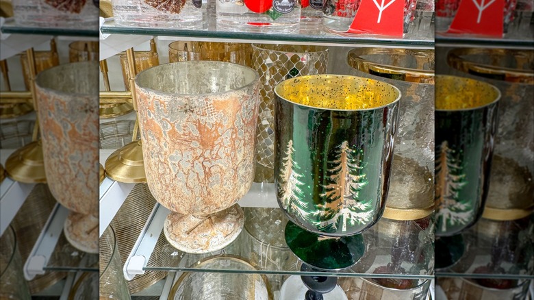 A Christmassy goblet in green and gold with white evergreen trees
