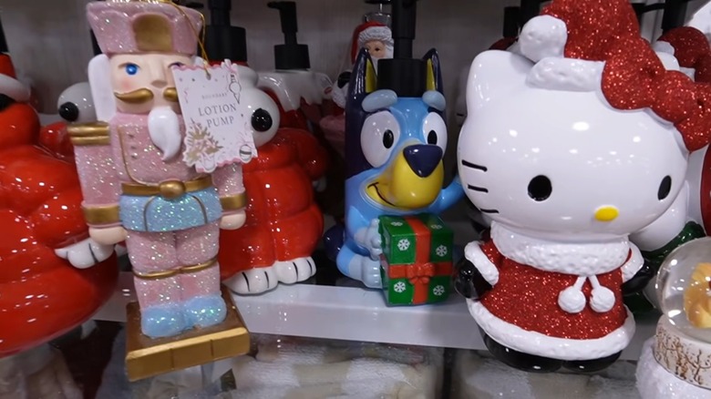 An assortment of soap and lotion pumps including designs with nutcrackers, Snoopy from Peanuts, a blue cartoon dog, and Christmas Hello Kitty