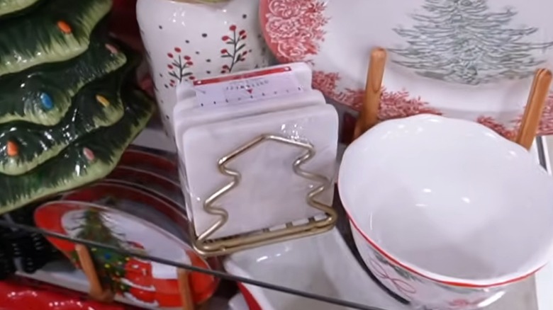 Four white marble coasters in a gold-colored Christmas tree-shaped holder
