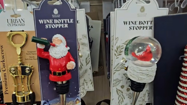 Wine bottle stoppers shaped like a drinking Santa and a snow globed cardinal
