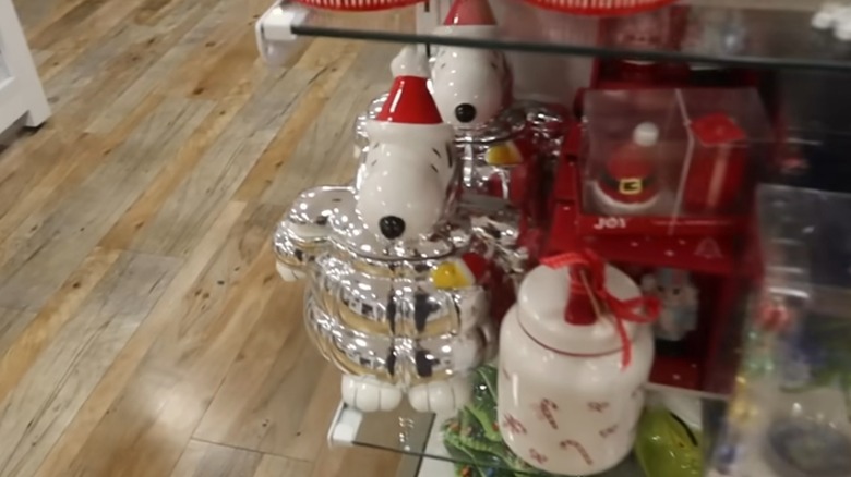 A Snoopy cookie jar in a puffy silver coat with Woodstock in his pocket